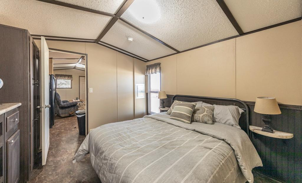 145 Lakesite Drive Spur, TX 79370 - Photo 7 of 20 a bedroom with a bed and wooden floor