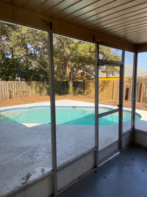 6429 Langston Avenue New Port Richey, FL 34653 - Photo 13 of 14 a view of backyard with floor to ceiling window and wooden fence