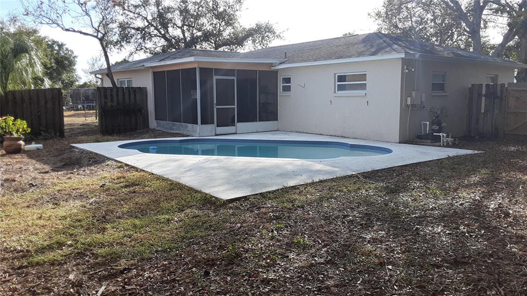 6429 Langston Avenue New Port Richey, FL 34653 - Photo 14 of 14 a view of a backyard with large trees