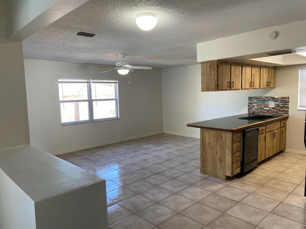 6429 Langston Avenue New Port Richey, FL 34653 - Photo 2 of 14 a kitchen with stainless steel appliances granite countertop a stove a sink and a refrigerator