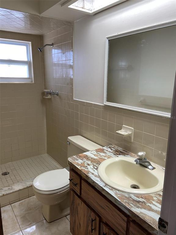 6429 Langston Avenue New Port Richey, FL 34653 - Photo 8 of 14 a bathroom with a sink a toilet and mirror