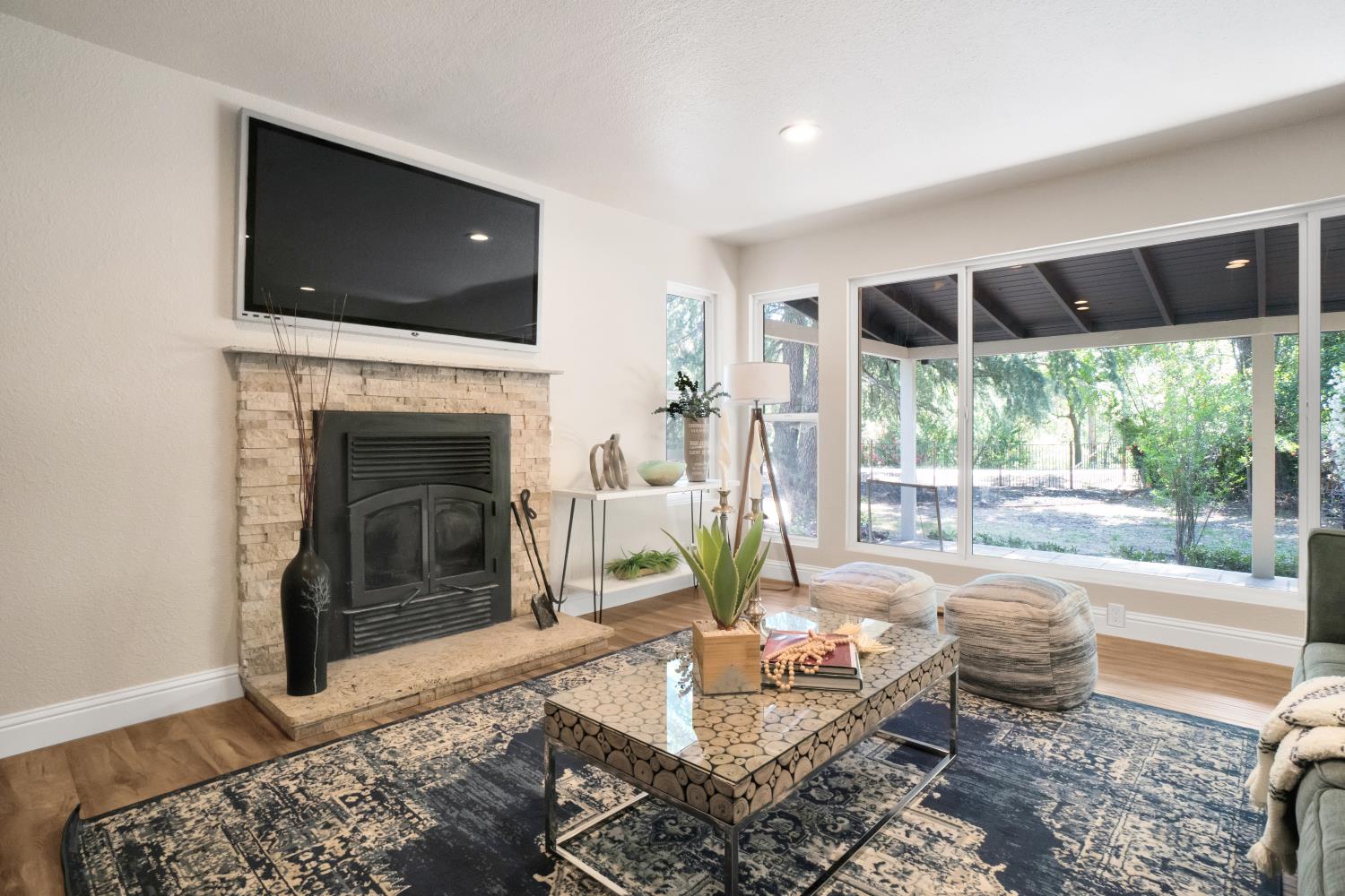 6299 Horseshoe Bar Road Loomis, CA 95650 - Photo 4 of 43 a living room with furniture a flat screen tv and a fireplace