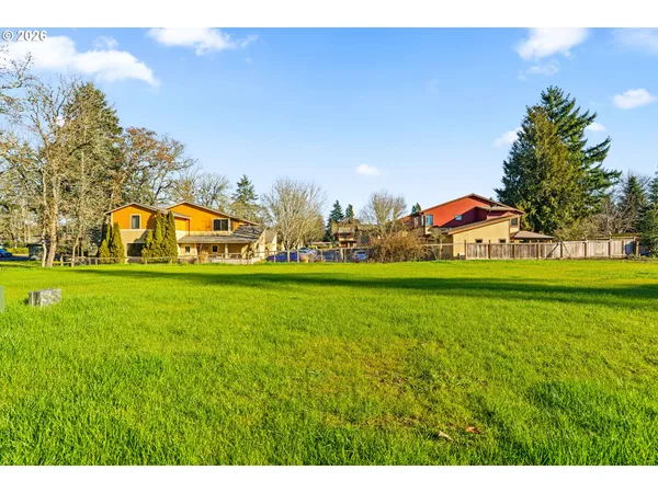 a view of yard with swimming pool and green space