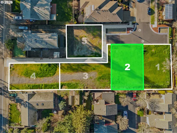 an aerial view of a house with a garden and a yard