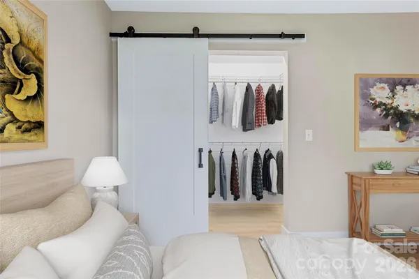 a spacious bedroom with a large bed and a chandelier