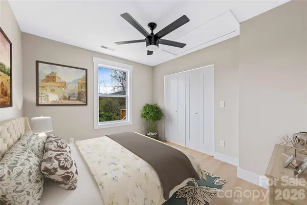 a bedroom with a bed and a potted plant