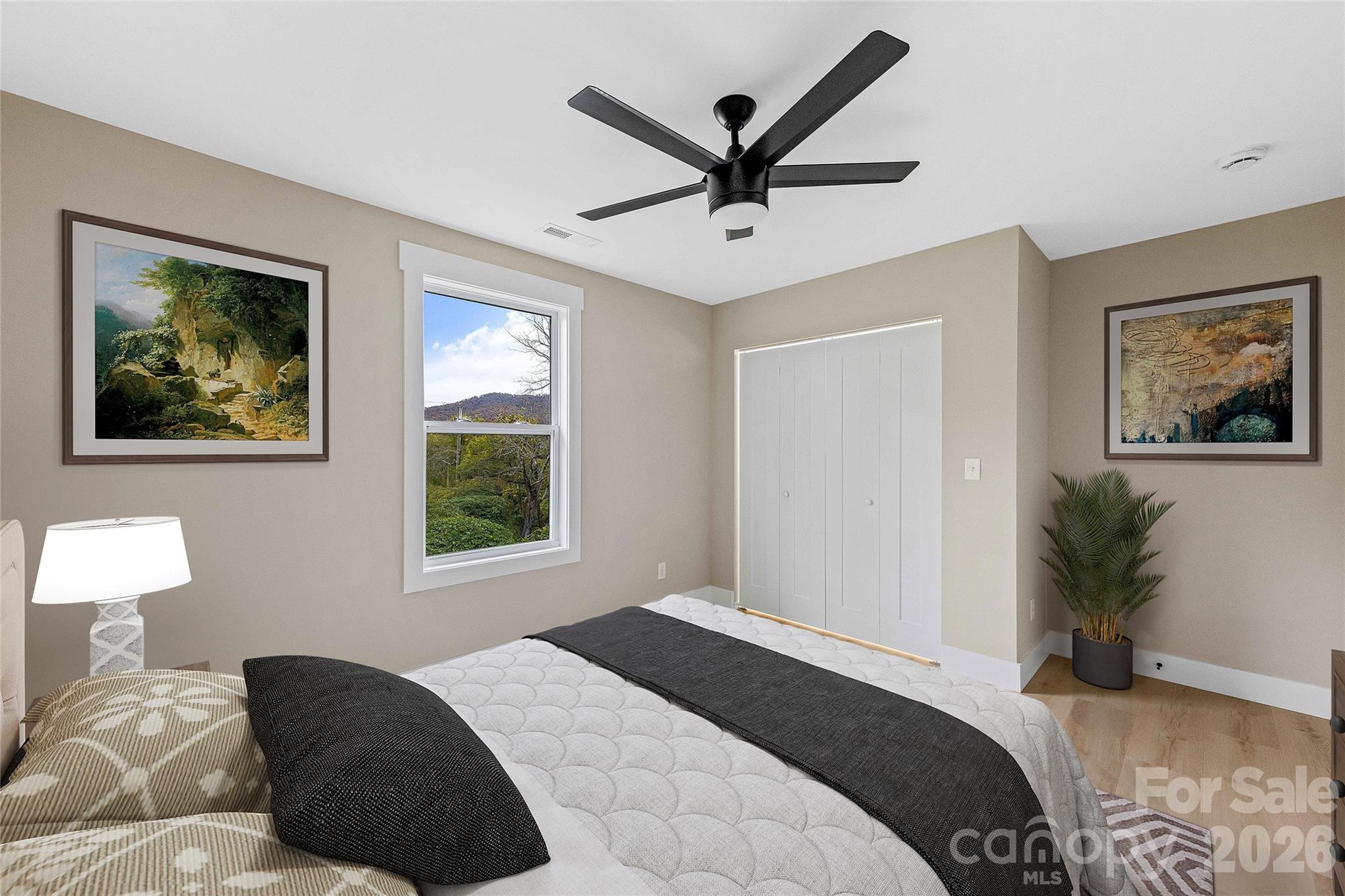 634 Beehive Road Hendersonville, NC 28792 - Photo 38 of 44 a bedroom with a large bed and a window