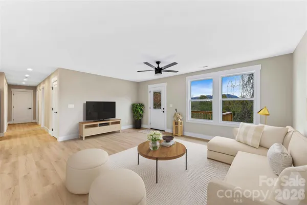 a view of kitchen with stainless steel appliances granite countertop a stove a sink and a refrigerator with wooden floor