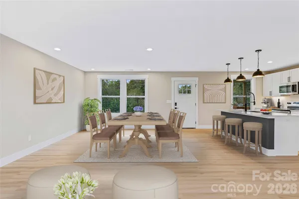 a view of a kitchen with wooden floor and window