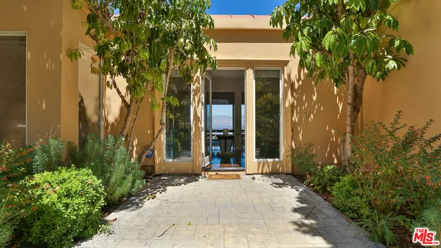 front view of a brick house with a small yard