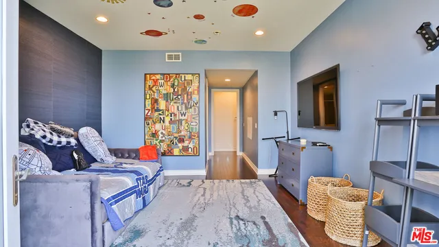 a bedroom with bed and glass windows