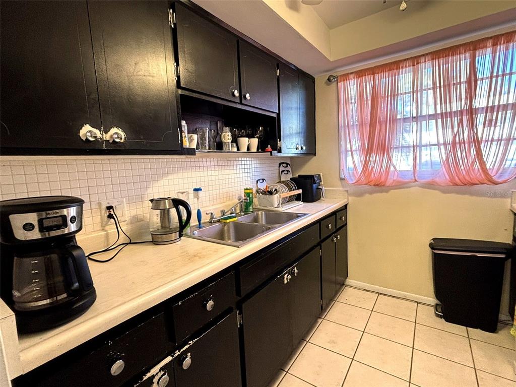 1433 South Belcher Road, Unit B2 Clearwater, FL 33764 - Photo 4 of 20 a kitchen with a sink cabinets and a stove top oven