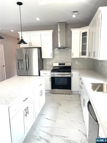 a large kitchen with a stove sink and cabinets
