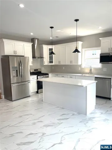 a view of kitchen with stainless steel appliances granite countertop a sink a counter space and stainless steel appliances
