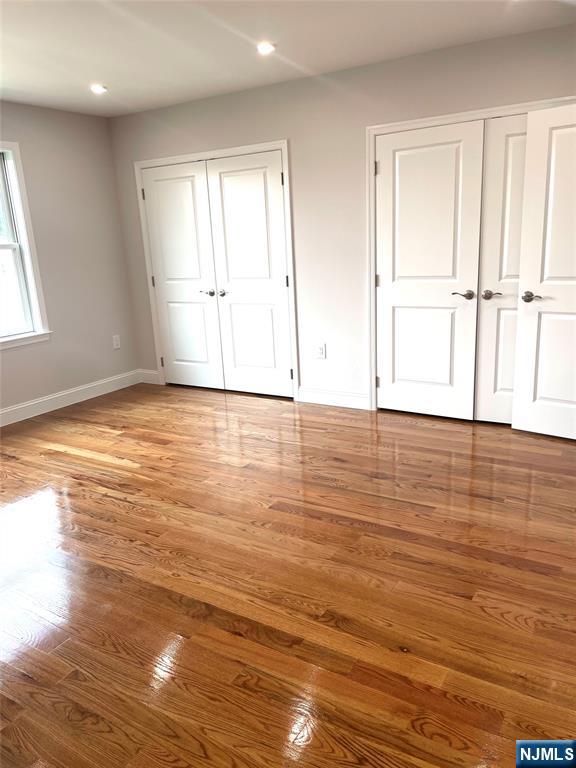 761 B 4th Street Secaucus, NJ 07094 - Photo 18 of 34 an empty room with wooden floor and windows