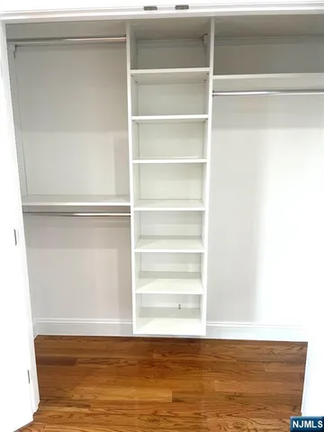 a view of a room with wooden floor