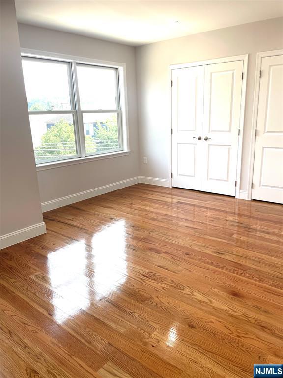761 B 4th Street Secaucus, NJ 07094 - Photo 28 of 34 an empty room with wooden floor and windows