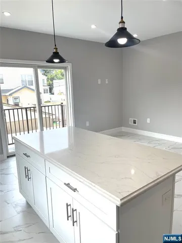 a kitchen with stainless steel appliances a white roof top oven a sink and a chandelier