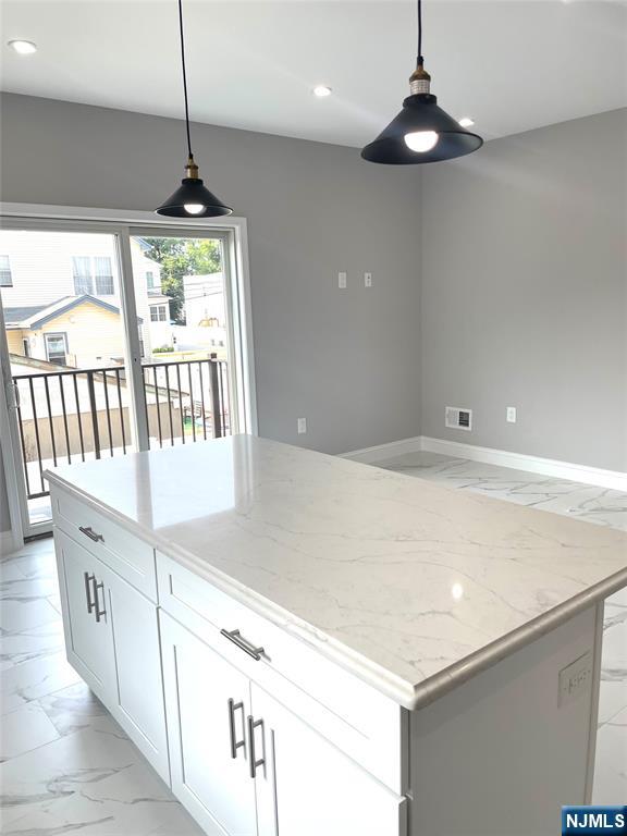 761 B 4th Street Secaucus, NJ 07094 - Photo 6 of 34 a kitchen with stainless steel appliances a white roof top oven a sink and a chandelier