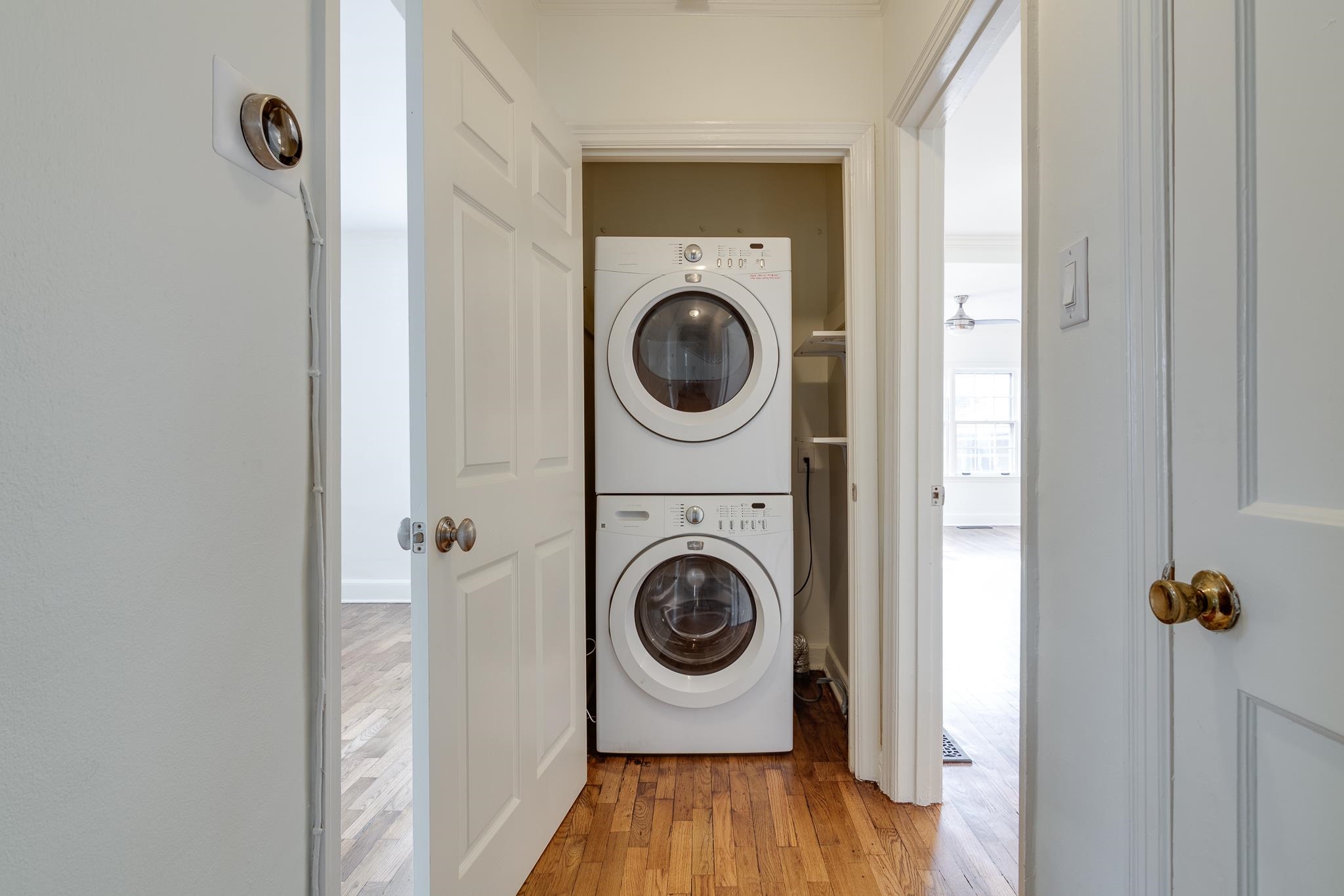 2767 Iroquois Road Memphis, TN 38111 - Photo 28 of 28 Laundry area featuring stacked washer and clothes dryer and light wood-type flooring
