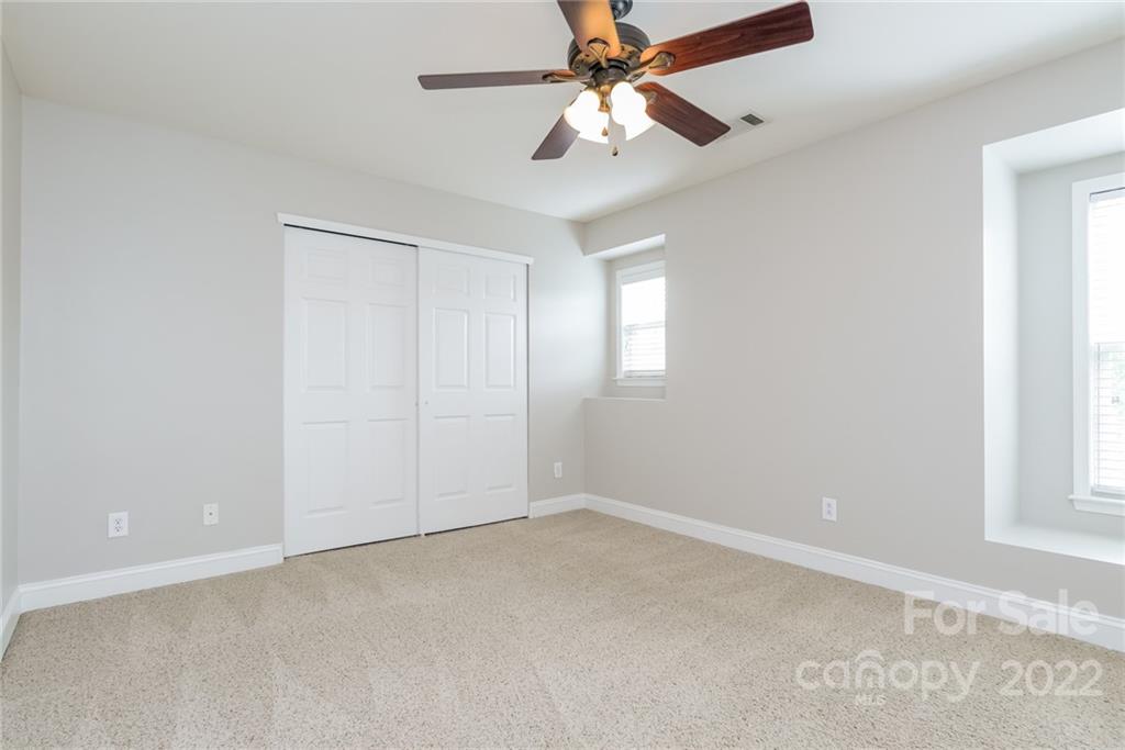 9337 Seamill Road Charlotte, NC 28278 - Photo 11 of 15 an empty room with windows and fan