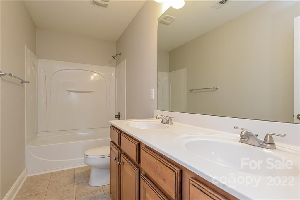 9337 Seamill Road Charlotte, NC 28278 - Photo 12 of 15 a bathroom with a sink a toilet and shower
