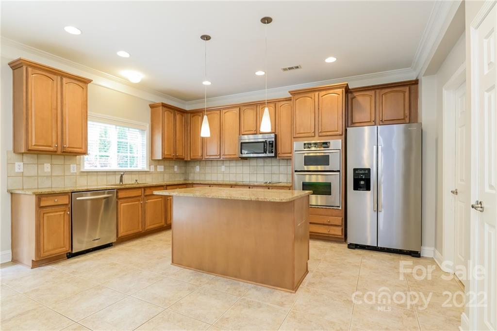 9337 Seamill Road Charlotte, NC 28278 - Photo 5 of 15 a large kitchen with stainless steel appliances granite countertop a refrigerator a sink dishwasher a stove and a refrigerator