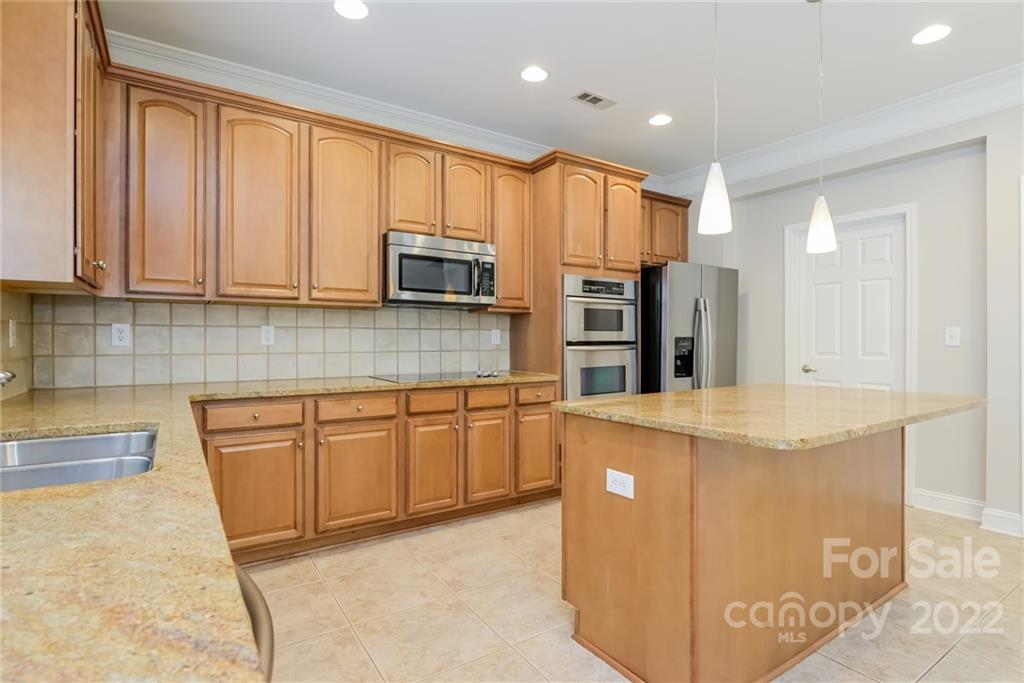 9337 Seamill Road Charlotte, NC 28278 - Photo 6 of 15 a kitchen with stainless steel appliances granite countertop a refrigerator a stove top oven a sink and dishwasher