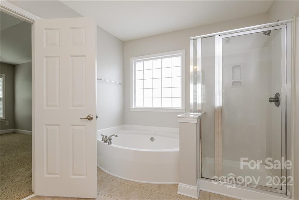 9337 Seamill Road Charlotte, NC 28278 - Photo 9 of 15 a white bath tub sitting next to a window