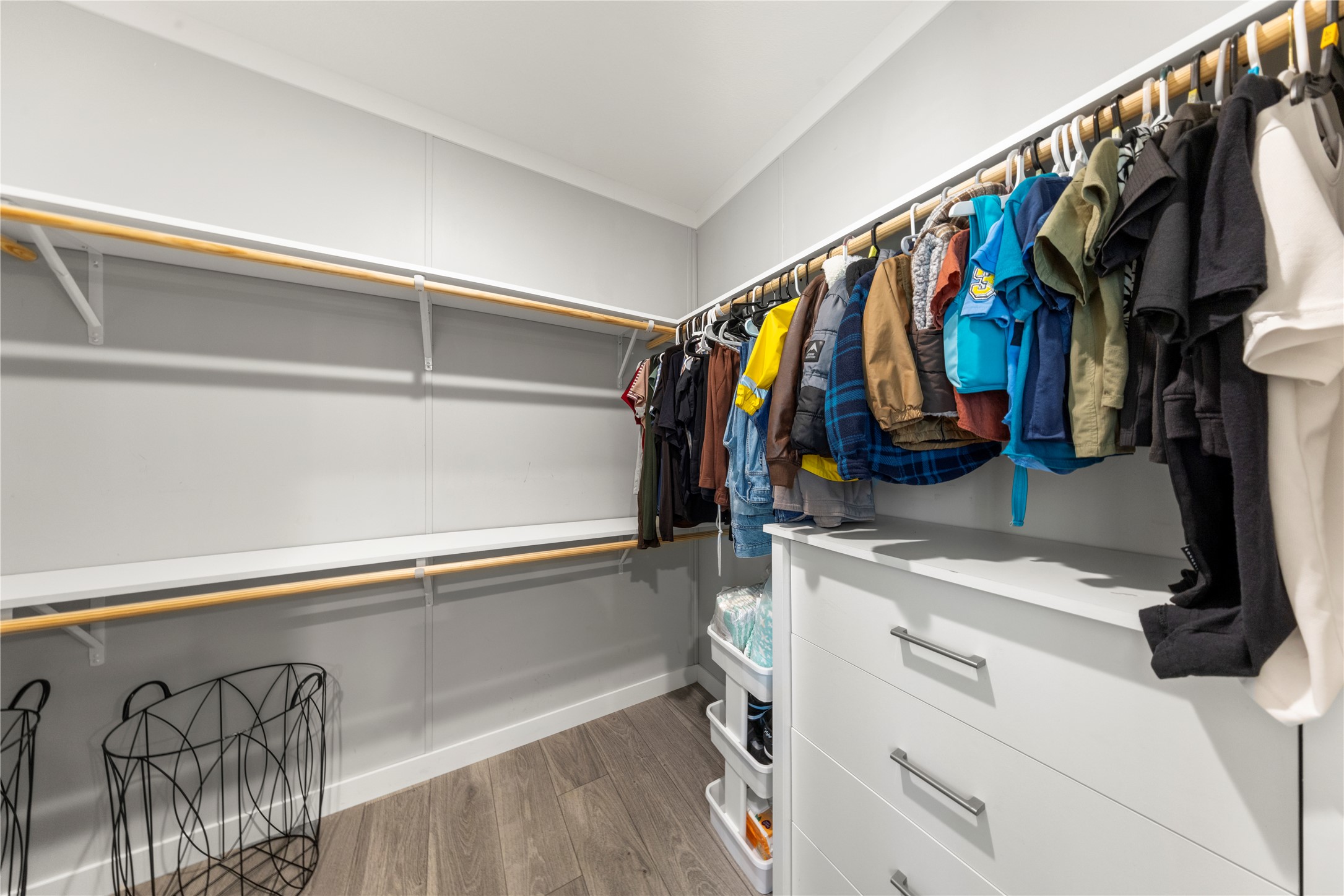 201 Greenfield Road Kyle, TX 78640 - Photo 13 of 28 Ample hanging space and integrated shelving create an organized wardrobe solution.