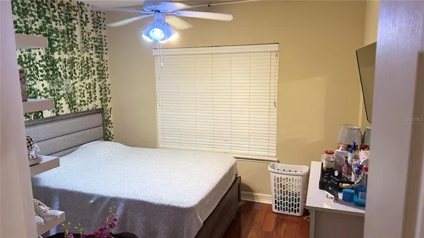 a bedroom with a bed and a window