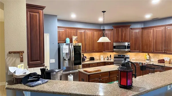a kitchen with a stove a sink and a refrigerator