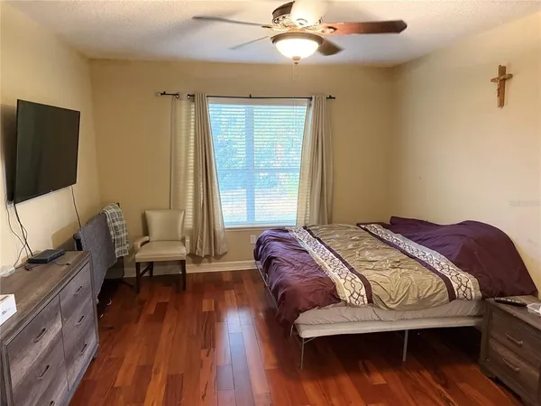 a bedroom with a bed and wooden floor