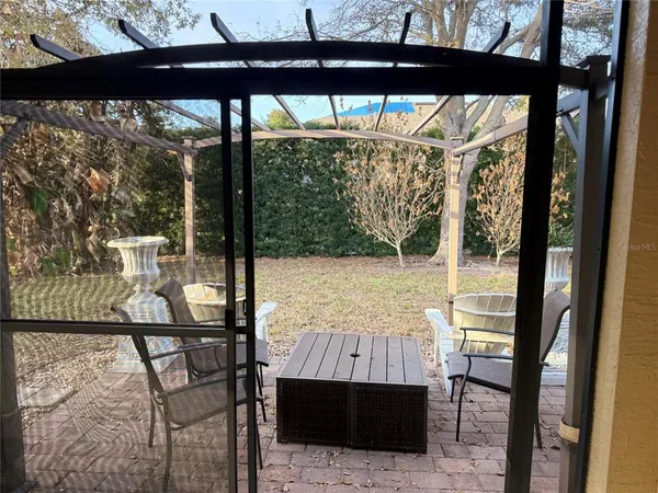a view of a room with a bed and wooden floor