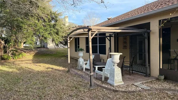 a view of a patio with table and chairs and potted plants