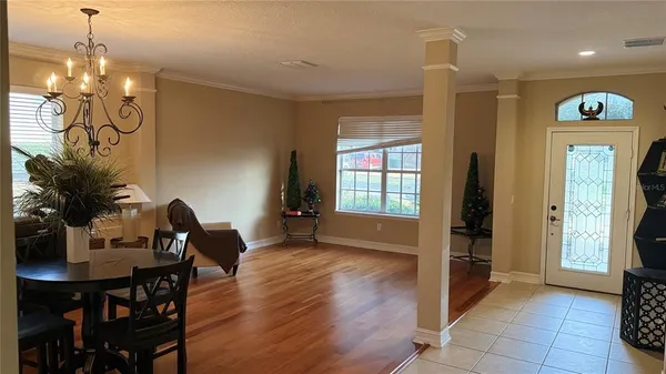 a view of a dining room with furniture window and wooden floor