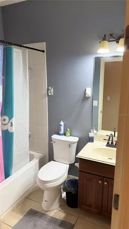 a bathroom with a sink a toilet a mirror and shower