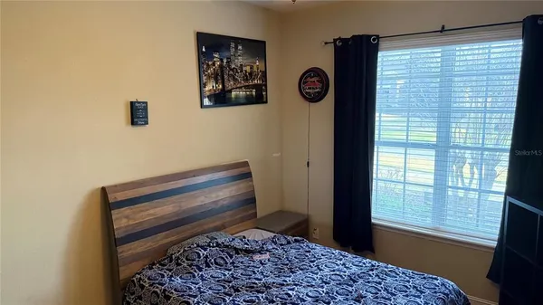 a bedroom with a bed and a window