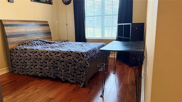 a bedroom with a bed and a window