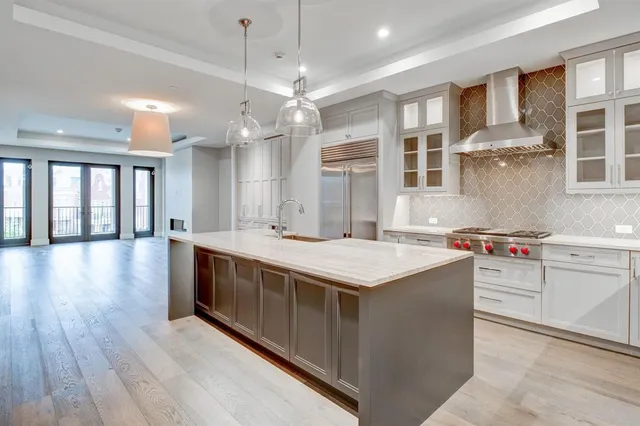 a kitchen with stainless steel appliances granite countertop a sink and stove