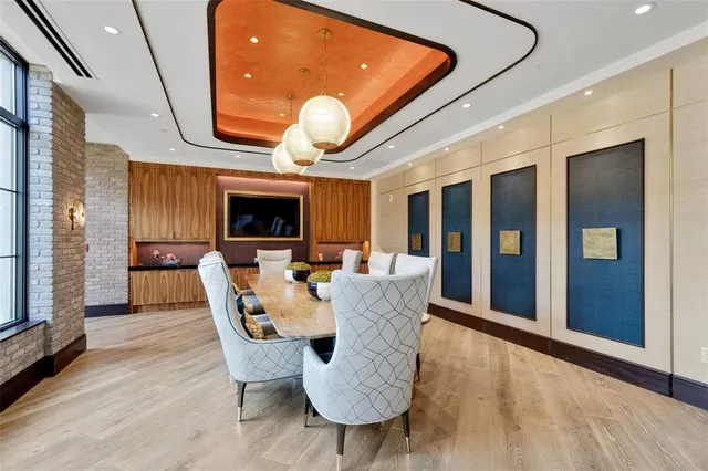 a view of a dining room with furniture wooden floor and a fireplace