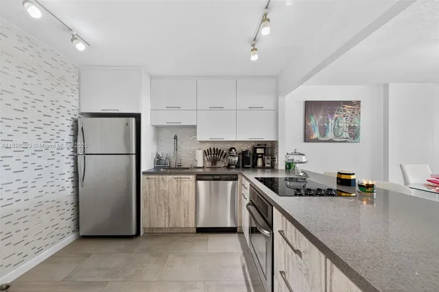 a kitchen with a refrigerator and a sink