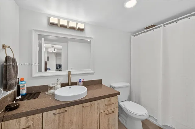 a bathroom with double sink and a mirror