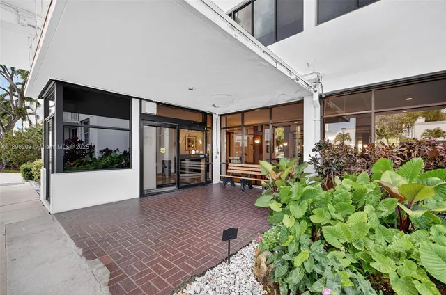 a view of a porch with chairs and front door