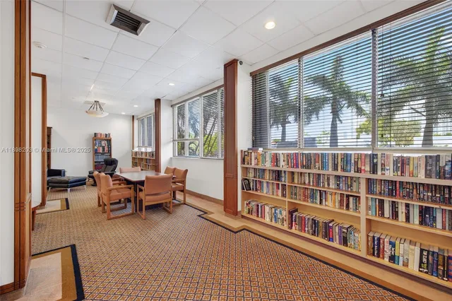 a reading room with furniture and a book shelf