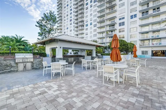 a view of a patio with table and chairs and potted plants