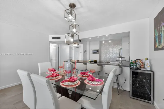 a view of a dining room with furniture and chandelier