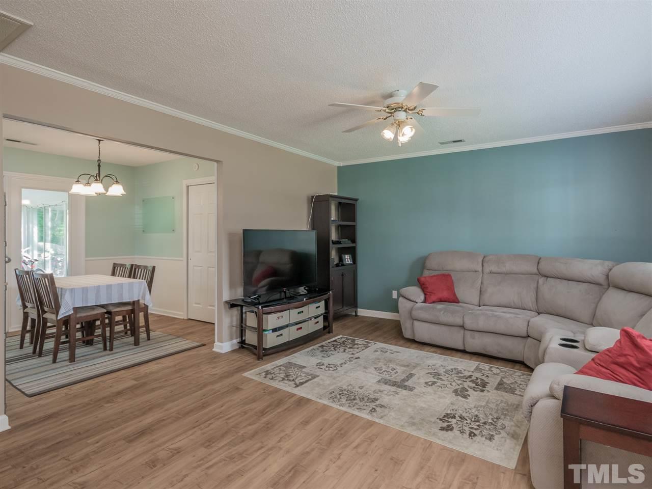 5402 Dorcas Street Raleigh, NC 27606 - Photo 5 of 18 a living room with furniture and a flat screen tv