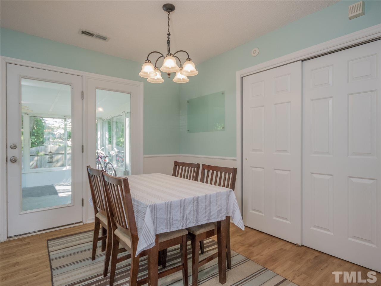 5402 Dorcas Street Raleigh, NC 27606 - Photo 7 of 18 a view of a dining room with furniture wooden floor and chandelier
