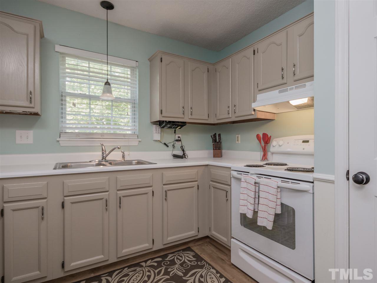 5402 Dorcas Street Raleigh, NC 27606 - Photo 9 of 18 a kitchen with cabinets appliances and a window